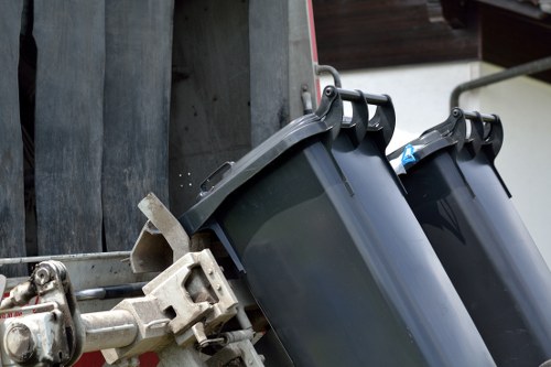 Homeowner organizing garage items for clearance in Hainault